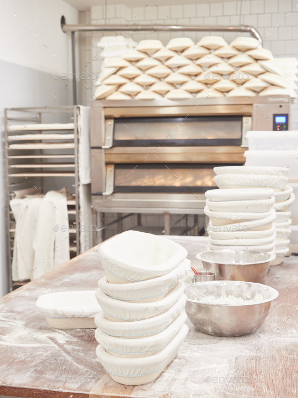scene inside a bakery work table for kneading bread with stacked bread